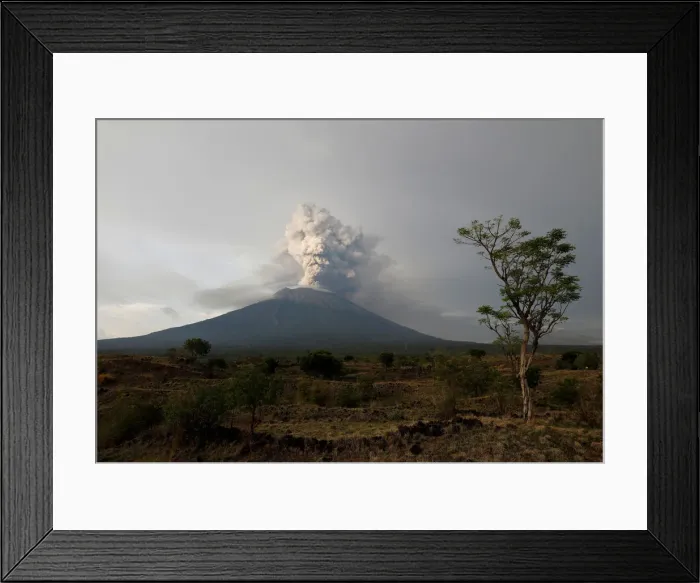 Framed Print : Mount Agung volcano erupts as seen from Kubu