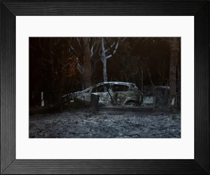 Framed Print : A burnt car sits in a burnt camping area following a forest fire near Donana National Framed Print : A burnt car sits in a burnt camping area following a forest fire near Donana National
