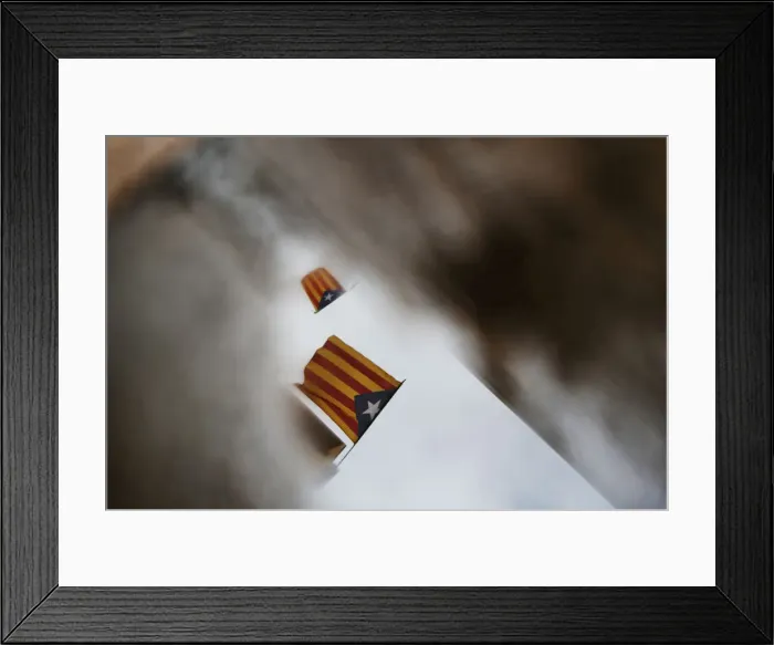 Framed Print : Esteladas are reflected in a puddle of water three days after the banned independence Framed Print : Esteladas are reflected in a puddle of water three days after the banned independence