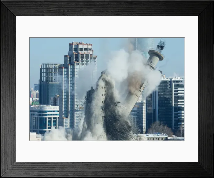Framed Print : The unfinished and abandoned TV tower collapses during a controlled demolition in Framed Print : The unfinished and abandoned TV tower collapses during a controlled demolition in