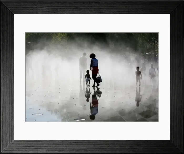 Framed Print : People gather near fountains of water as they cool off at the Miroir d Eau