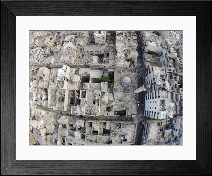 Framed Print : A aerial view shows a damaged mosque and surrounding buildings in the Al-Maysar Framed Print : A aerial view shows a damaged mosque and surrounding buildings in the Al-Maysar