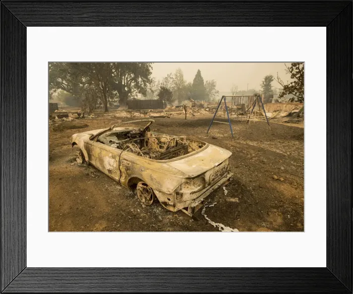 Framed Print : Burned out remains of a vehicle and swing set scorched by the Valley Fire line Jefferson