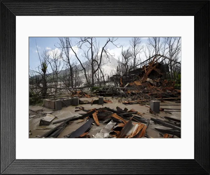 Framed Print : A house destroyed by the eruption of Mount Sinabung is seen in an abandoned plantation in