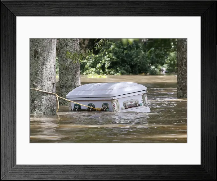 Framed Print : A casket is seen floating in flood waters in Ascension Parish