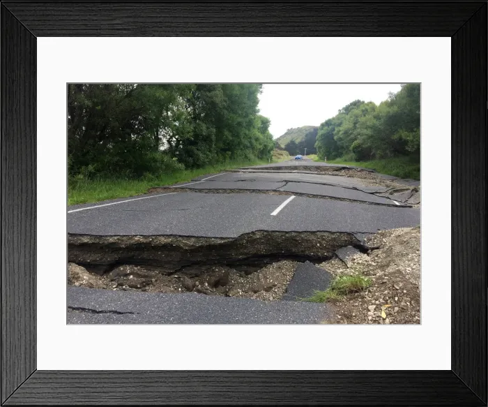Framed Print : A fractured road caused by an earthquake stops vehicle access 70 kilometers south of Framed Print : A fractured road caused by an earthquake stops vehicle access 70 kilometers south of