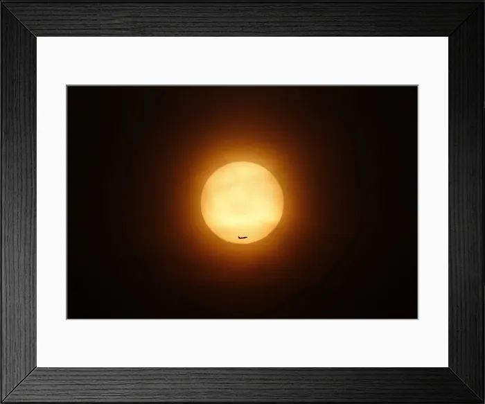 Framed Print : A passenger jet flies past the setting sun in Shanghai Framed Print : A passenger jet flies past the setting sun in Shanghai