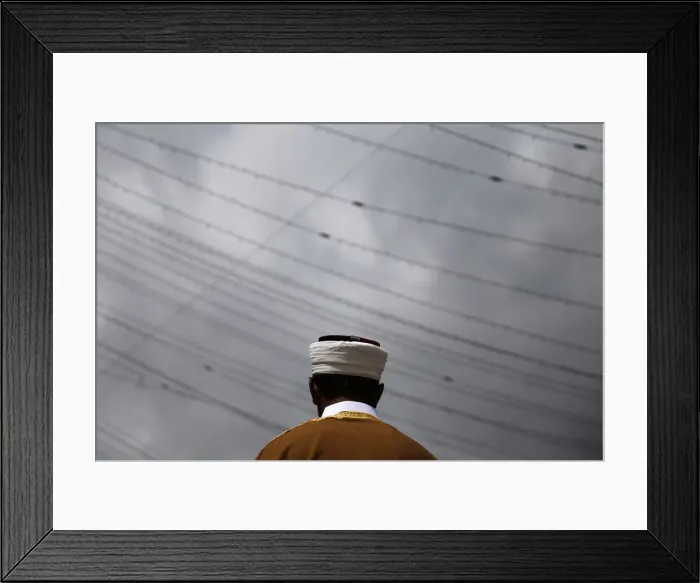 Framed Print : An imam leads Eid al-Fitr services as Muslim worshippers pray in the Queens borough of