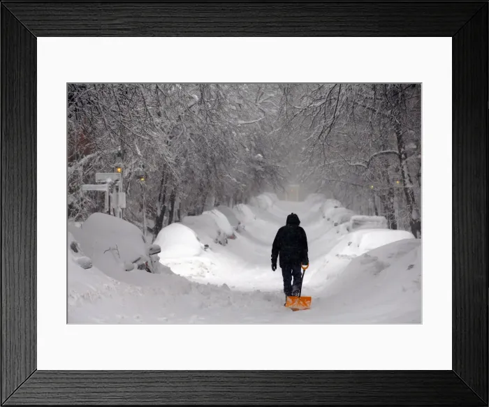 Framed Print : A man drags a shovel up Beacon Hill during a severe winter snow storm in Boston Framed Print : A man drags a shovel up Beacon Hill during a severe winter snow storm in Boston