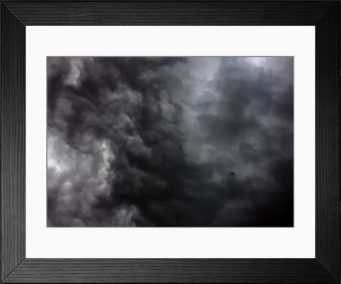 Framed Print : A Qantas Airways Boeing 737-800 plane flies near storm clouds above Sydney