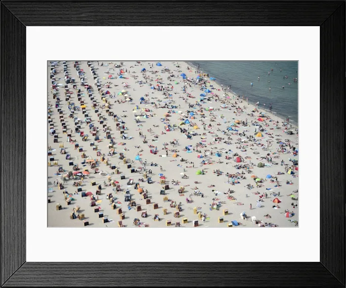 Framed Print : People sitting in beach chairs enjoy the hot sunny weather at the Baltic Sea resort