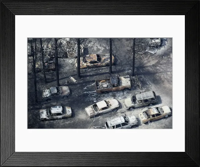Framed Print : An aerial view of burned out vehicles in the aftermath of the Black Forest Fire in Black