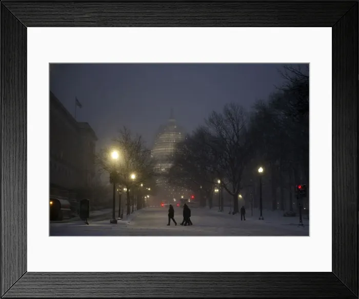 Framed Print : People walk in the falling snow near the U. S. Capitol in Washington