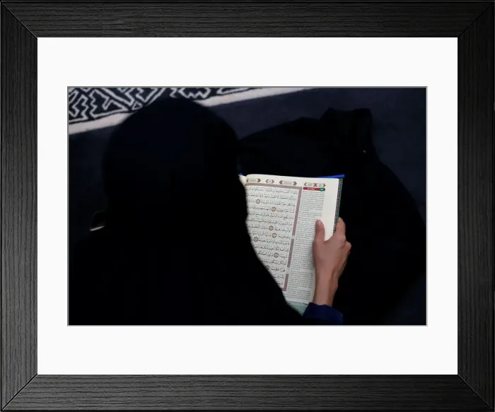 Framed Print : A woman reads Koran at a mosque in Jakarta Framed Print : A woman reads Koran at a mosque in Jakarta