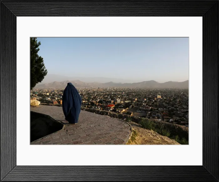 Framed Print : An Afghan woman walks on a hilltop overlooking Kabul, Afghanistan