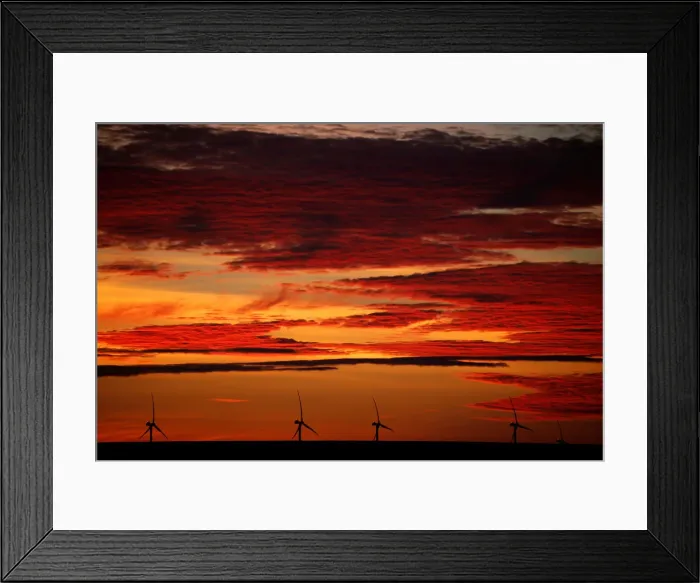 Framed Print : A power-generating windmill turbine is pictured during sunrise at a wind park in Framed Print : A power-generating windmill turbine is pictured during sunrise at a wind park in