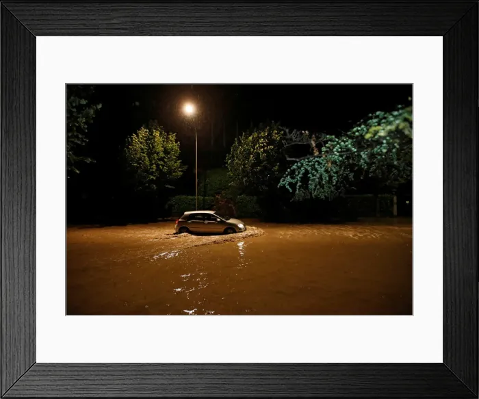 Framed Print : A car drives through water on the Quai d Ouchy after a flash flooding during a heavy rain Framed Print : A car drives through water on the Quai d Ouchy after a flash flooding during a heavy rain