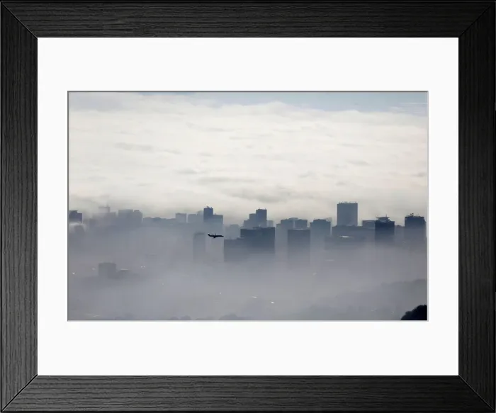 Framed Print : An airplane flies over buildings in Rio de Janeiro Framed Print : An airplane flies over buildings in Rio de Janeiro