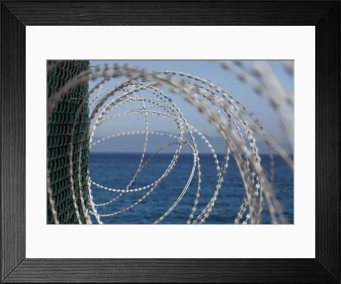 Framed Print : The border fence separating Spains northern enclave Ceuta and Morocco is seen from Ceuta