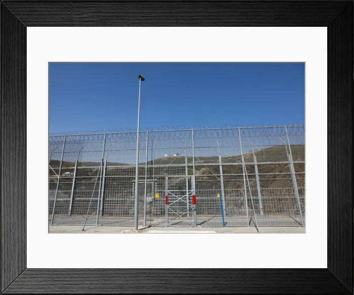 Framed Print : The border fence separating Spains northern enclave Ceuta and Morocco is seen from Ceuta Framed Print : The border fence separating Spains northern enclave Ceuta and Morocco is seen from Ceuta
