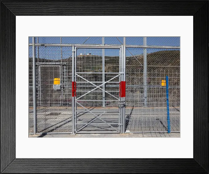 Framed Print : The border fence separating Spains northern enclave Ceuta and Morocco is seen from Ceuta Framed Print : The border fence separating Spains northern enclave Ceuta and Morocco is seen from Ceuta