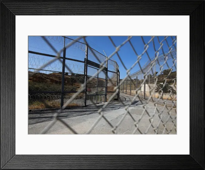 Framed Print : The border fence separating Spains northern enclave Ceuta and Morocco is seen from Ceuta