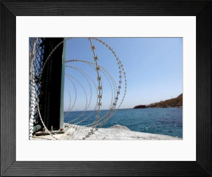 Framed Print : The border fence separating Spains northern enclave Ceuta and Morocco is seen from Ceuta Framed Print : The border fence separating Spains northern enclave Ceuta and Morocco is seen from Ceuta