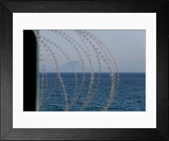 Framed Print : The border fence separating Spains northern enclave Ceuta and Morocco is seen from Ceuta Framed Print : The border fence separating Spains northern enclave Ceuta and Morocco is seen from Ceuta