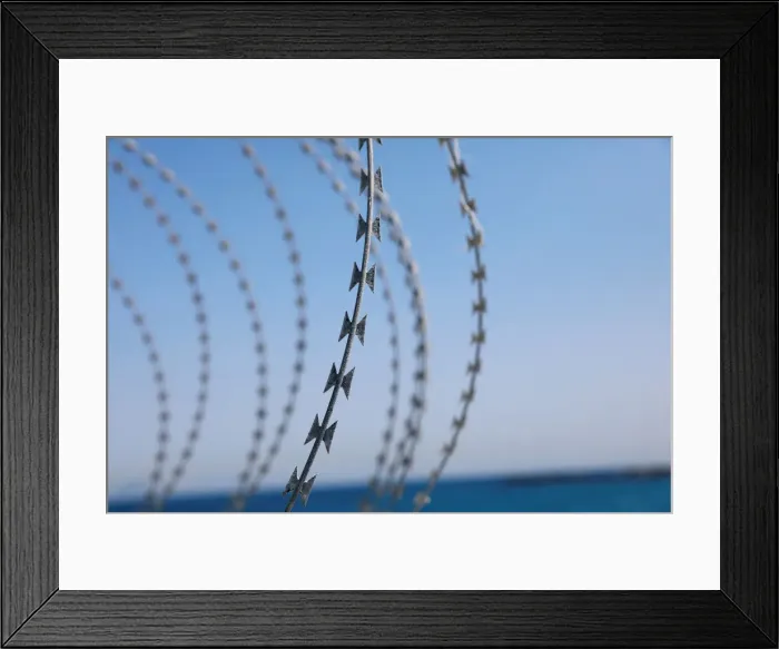 Framed Print : The border fence separating Spains northern enclave Ceuta and Morocco is seen from Ceuta Framed Print : The border fence separating Spains northern enclave Ceuta and Morocco is seen from Ceuta