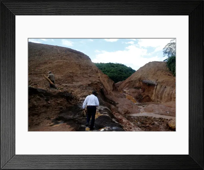 Framed Print : Residents tour the dam that burst its walls, overrunning nearby homes Framed Print : Residents tour the dam that burst its walls, overrunning nearby homes
