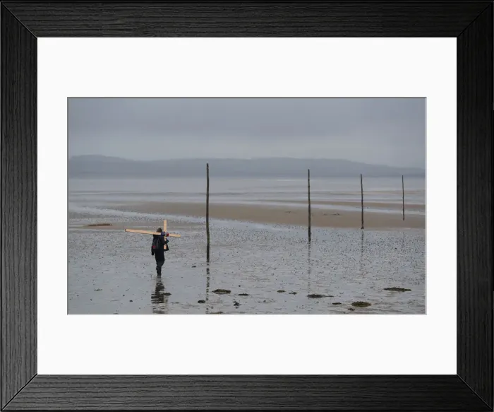 Framed Print : A pilgrim walks accross a tidal causeway on the final leg of the Northern Cross Framed Print : A pilgrim walks accross a tidal causeway on the final leg of the Northern Cross