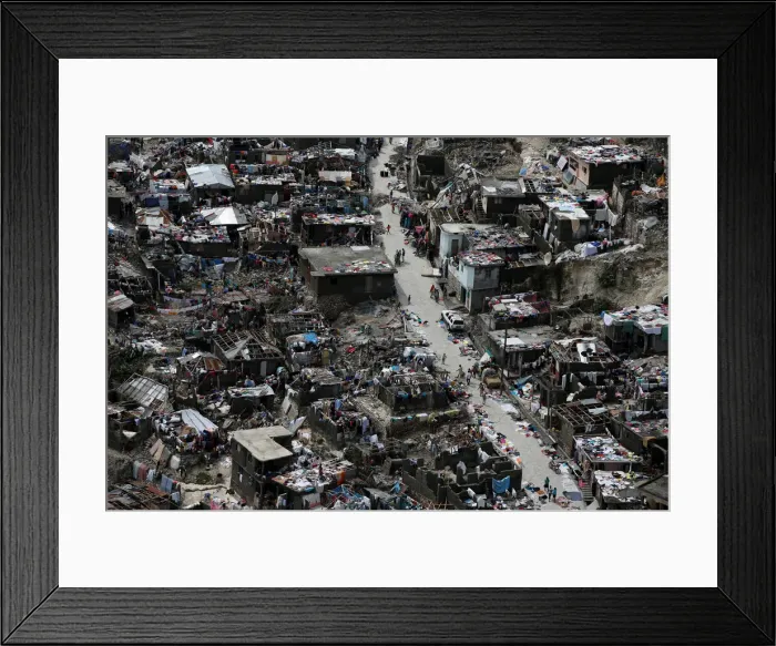 Framed Print : People walk on a street next to destroyed houses after Hurricane Matthew hit Jeremie Framed Print : People walk on a street next to destroyed houses after Hurricane Matthew hit Jeremie