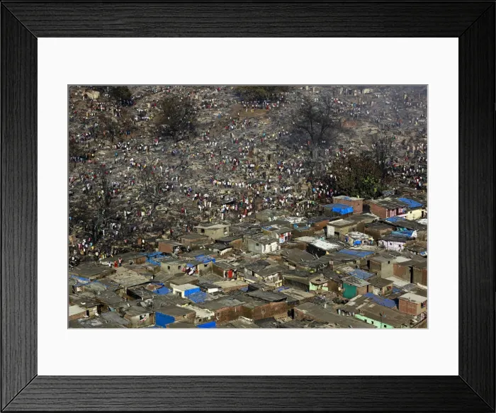 Framed Print : Residents attempt to salvage belongings from gutted hutments in a slum area in Mumbai