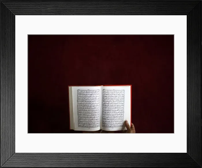 Framed Print : A Nepalese Muslim reads the Koran during the month-long fasting in the holy month of