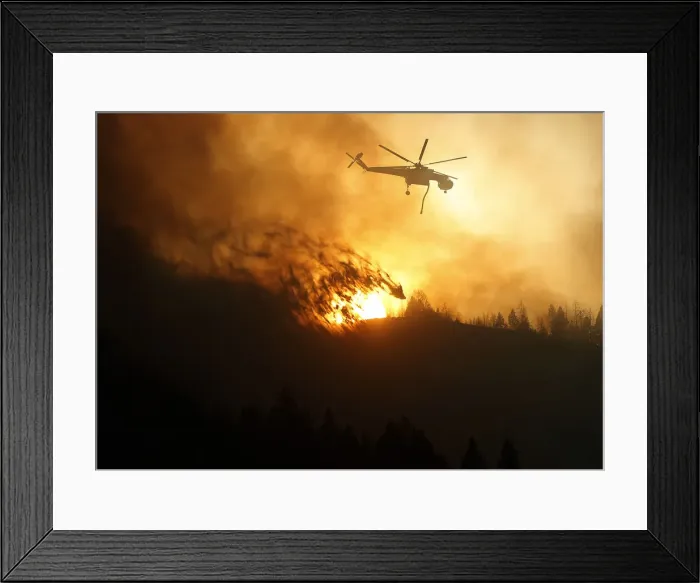 Framed Print : A helicopter air tanker dumps water as the sun sets at the Beaver Creek wildfire outside Framed Print : A helicopter air tanker dumps water as the sun sets at the Beaver Creek wildfire outside