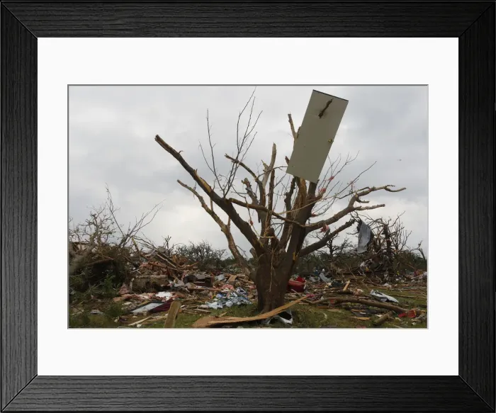 Framed Print : The door of a house is impaled on a tree after tornados swept through the town of