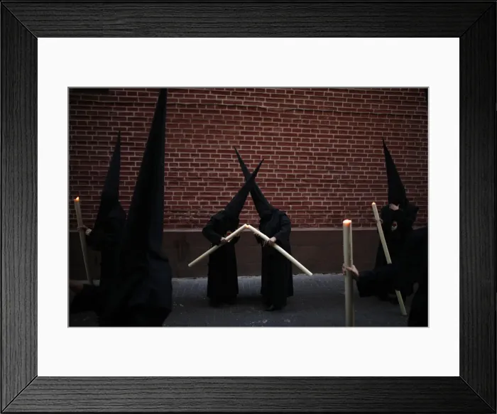 Framed Print : Penitents light their candles as they take part in the Calvario brotherhood procession Framed Print : Penitents light their candles as they take part in the Calvario brotherhood procession