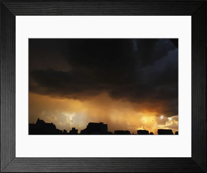 Framed Print : Buenos Aires city skylike is seen as a storm approaches at sunset Framed Print : Buenos Aires city skylike is seen as a storm approaches at sunset