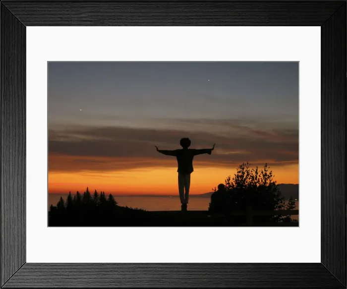 Framed Print : A man balances on a fence post as he watches the sun set over the Pacific Ocean in Santa Framed Print : A man balances on a fence post as he watches the sun set over the Pacific Ocean in Santa