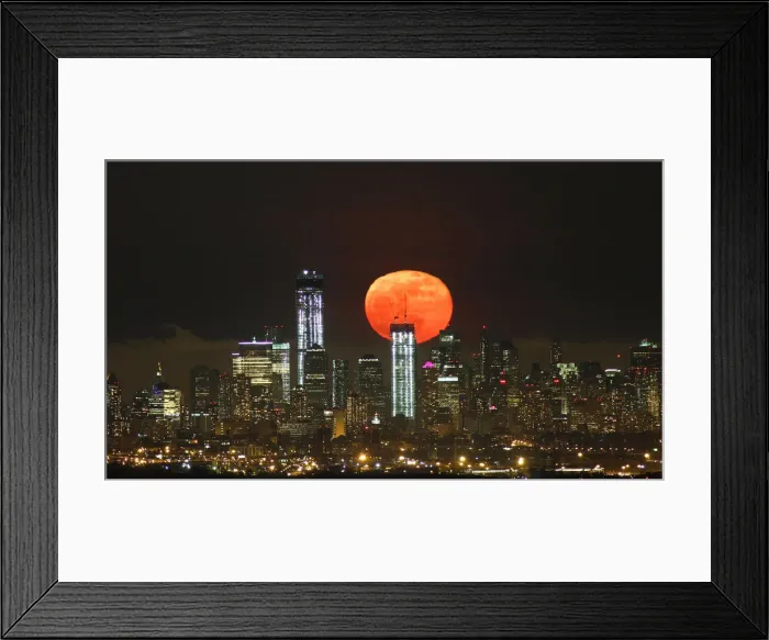 Framed Print : A full moon as seen from West Orange, New Jersey, rises over the skyline of Lower