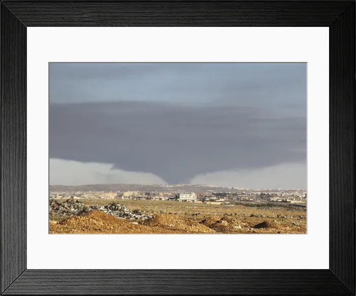 Framed Print : Smoke rises over the industrial city in Aleppo, Syria