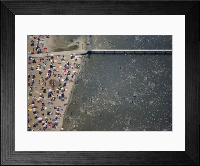 Framed Print : People sunbathe and swim at the beach of Wannsee near Berlin Framed Print : People sunbathe and swim at the beach of Wannsee near Berlin