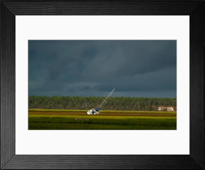 Framed Print : A boat is seen after being blown from the dock into the marsh after Hurricane Irma passed