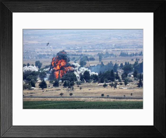 Framed Print : An explosion is seen at Quneitra at the Syrian side of the Israeli Syrian border as it is Framed Print : An explosion is seen at Quneitra at the Syrian side of the Israeli Syrian border as it is