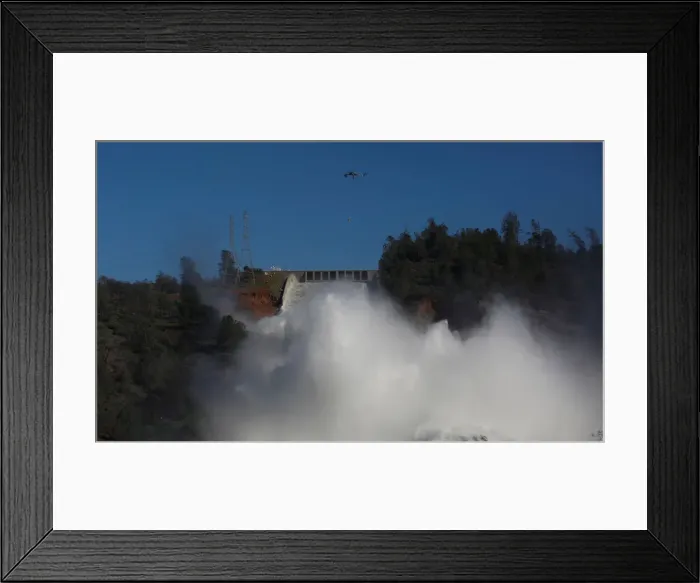 Framed Print : Helicopters carry rocks as water is released from the Lake Oroville Dam after an Framed Print : Helicopters carry rocks as water is released from the Lake Oroville Dam after an