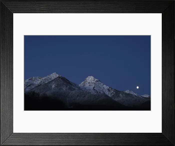 Framed Print : The moon is seen over the mountain ahead of the womens parallel giant slalom competition Framed Print : The moon is seen over the mountain ahead of the womens parallel giant slalom competition