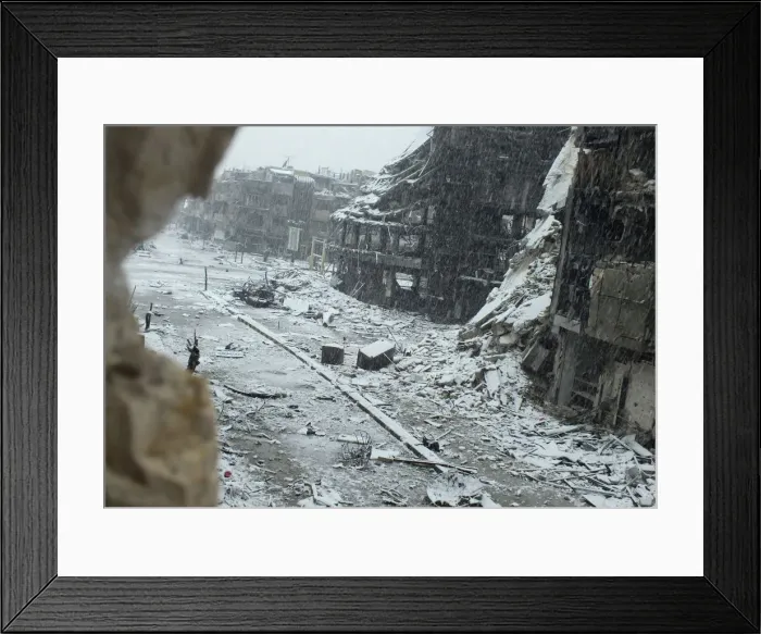 Framed Print : Snow falls over damaged buildings at Jouret al Shayah area in Homs