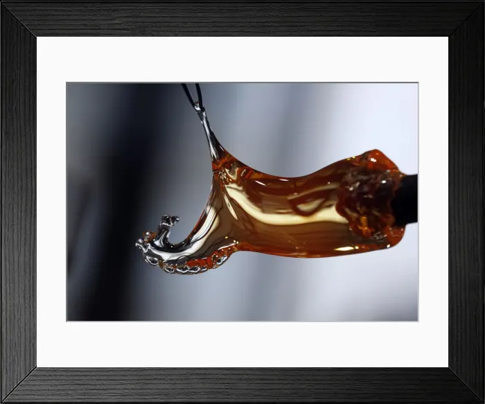 Framed Print : Master glassmaker uses tweezers to create a handmade horse glass at Royal Crystal Factory