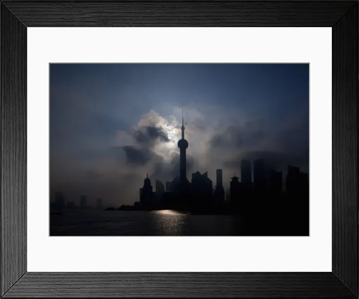 Framed Print : An eclipse is seen in at the Bund along the Huangpu River in Shanghai
