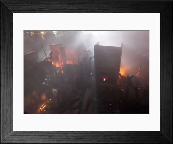 Framed Print : Residents walk with flashlights as they return to their burned homes during a fire in Framed Print : Residents walk with flashlights as they return to their burned homes during a fire in